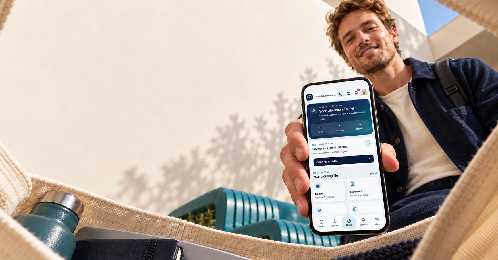 Looking out from inside a jute bag, a man holds his phone towards the camera showing the MyDekela app.